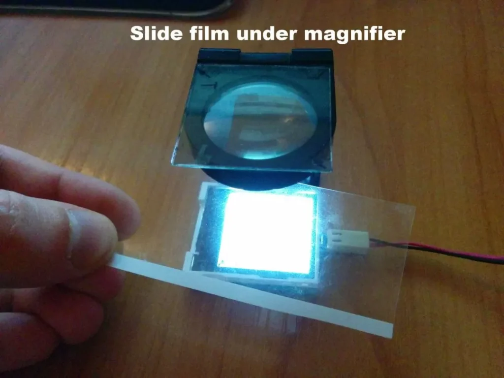 Slide film under magnifier